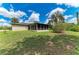 Home's backyard with well-maintained lawn and an enclosed porch at 5482 Globe Ter, North Port, FL 34286