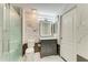Elegant bathroom features marble walls, glass shower and gray vanity cabinet at 5482 Globe Ter, North Port, FL 34286
