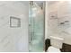 Contemporary bathroom with glass shower enclosure, white marble walls, and modern fixtures at 5482 Globe Ter, North Port, FL 34286