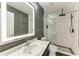 Modern bathroom featuring gray and white marble walls, sleek fixtures, and glass-enclosed shower at 5482 Globe Ter, North Port, FL 34286