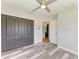 Bedroom with gray walls, wood-look floors, ceiling fan, and large closet at 5482 Globe Ter, North Port, FL 34286