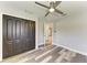 Bedroom featuring gray walls, wood-look floors, ceiling fan, and large closet at 5482 Globe Ter, North Port, FL 34286