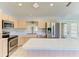 Bright kitchen featuring stainless steel appliances and a functional center island at 5482 Globe Ter, North Port, FL 34286