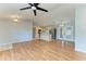 Open-concept living space with hardwood floors, connecting to the kitchen and dining area at 5482 Globe Ter, North Port, FL 34286