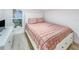 Cozy bedroom featuring a comfortable bed, stylish dresser, and ample natural light from the window at 55 Braden Castle Dr, Bradenton, FL 34208
