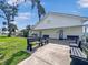 Exterior view of a well-maintained building with benches and a grassy lawn at 55 Braden Castle Dr, Bradenton, FL 34208