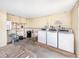 On-site laundry room with washing machines, dryer, sink, water heater and concrete floors at 55 Braden Castle Dr, Bradenton, FL 34208