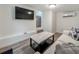 Modern living room featuring a large television, clean, simple decor and sleek furniture at 55 Braden Castle Dr, Bradenton, FL 34208