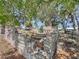 Interesting rock garden with foliage and trees, as well as community homes in the background at 55 Braden Castle Dr, Bradenton, FL 34208