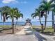 Scenic waterfront view featuring a gazebo and palm trees, creating a tranquil and inviting outdoor space at 55 Braden Castle Dr, Bradenton, FL 34208