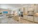 Modern kitchen with stainless steel appliances, granite countertops, and seamless flow to living area at 5622 Arnie Loop, Lakewood Ranch, FL 34211