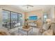 Cozy living room with a plush sofa, ceiling fan, and large sliding doors that open to an outdoor space at 5622 Arnie Loop, Lakewood Ranch, FL 34211