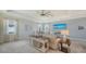 Spacious living room with tray ceilings, coastal decor, and an ocean view TV at 5622 Arnie Loop, Lakewood Ranch, FL 34211