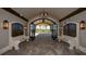 Grand lobby with wrought iron gates leading to an open area, complemented by stone benches and sconce lighting at 5622 Arnie Loop, Lakewood Ranch, FL 34211