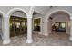 An inviting lobby with stone-tiled floors, arched entrances, and clear doors to a fitness center and spa at 5622 Arnie Loop, Lakewood Ranch, FL 34211