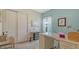 Bright office space with white desk, tile flooring and custom storage solutions at 5622 Arnie Loop, Lakewood Ranch, FL 34211