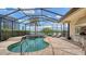 Beautiful screened-in pool with spa and lake view, perfect for relaxation at 5622 Arnie Loop, Lakewood Ranch, FL 34211