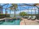 Relaxing pool with attached spa, screened in enclosure, and scenic water views creating an outdoor oasis at 5622 Arnie Loop, Lakewood Ranch, FL 34211