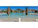 Stunning community pool with waterfalls and palm trees offering a resort-style living experience at 5622 Arnie Loop, Lakewood Ranch, FL 34211