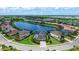 Stunning aerial view of a waterfront home with lush landscaping and a view of the community golf course at 5622 Arnie Loop, Lakewood Ranch, FL 34211