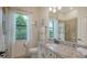 Bright bathroom offers a granite vanity, storage cabinets and private commode at 5622 Arnie Loop, Lakewood Ranch, FL 34211