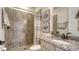 Elegant bathroom featuring granite counters, neutral toned shower, decorative art, and bronze fixtures at 5622 Arnie Loop, Lakewood Ranch, FL 34211