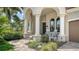 Inviting front porch with classic rocking chairs and lush landscaping at 5622 Arnie Loop, Lakewood Ranch, FL 34211