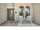 Welcoming front porch featuring rocking chairs, decorative windows, and a stylish front door at 5622 Arnie Loop, Lakewood Ranch, FL 34211