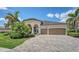 Charming home with meticulously maintained landscaping, a tile roof, and a brick-paved driveway at 5622 Arnie Loop, Lakewood Ranch, FL 34211