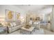 Bright living room open to the kitchen and featuring neutral furniture and stylish decor at 5622 Arnie Loop, Lakewood Ranch, FL 34211
