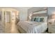 Stylish main bedroom with serene color palette, tiled floors and contemporary furnishings at 5622 Arnie Loop, Lakewood Ranch, FL 34211