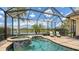 Inviting screened-in pool featuring spa, lake views and sun loungers for ultimate relaxation at 5622 Arnie Loop, Lakewood Ranch, FL 34211