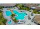 Stunning aerial view of the resort-style pool, featuring a waterfall, bridge, and plenty of lounge seating at 5622 Arnie Loop, Lakewood Ranch, FL 34211