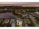 Stunning aerial shot of the property with lake view, surrounded by manicured lawns and beautiful landscaping at 5718 Title Row Dr, Bradenton, FL 34210