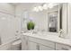 All-white bathroom features a tub, shower, white vanity, and a large mirror, creating a clean, modern aesthetic at 5718 Title Row Dr, Bradenton, FL 34210