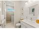 Clean, well-lit bathroom with white shiplap wall, white vanity, and walk-in shower with neutral tile at 5718 Title Row Dr, Bradenton, FL 34210