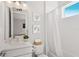 Bright, white bathroom with a vanity, shower, and nautical-themed artwork at 5718 Title Row Dr, Bradenton, FL 34210