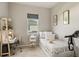 Cozy bedroom with a single bed, a desk area, and soft, neutral decor under a natural light from a window at 5718 Title Row Dr, Bradenton, FL 34210