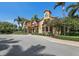 Beautiful building featuring a clay tile roof, multiple windows, and a charming balcony at 5718 Title Row Dr, Bradenton, FL 34210