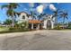 Exterior view of the attractive community clubhouse with beautiful landscaping at 5718 Title Row Dr, Bradenton, FL 34210
