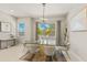 Inviting dining room with a modern glass table, stylish chairs, and decorative accents under a modern lighting fixture at 5718 Title Row Dr, Bradenton, FL 34210
