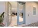 Elegant entryway showcasing modern blue double doors and a glimpse of the sunlit living area at 5718 Title Row Dr, Bradenton, FL 34210