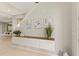 A modern entryway showcases a floating console table with art and plants, adding a touch of elegance at 5718 Title Row Dr, Bradenton, FL 34210