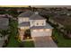 An aerial view of a grand two-story home with a three-car garage, lush landscaping, and elegant curb appeal at 5718 Title Row Dr, Bradenton, FL 34210