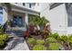 Charming front entrance with landscaped garden beds, stone steps, and a stately facade at 5718 Title Row Dr, Bradenton, FL 34210