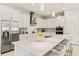 Beautiful kitchen with a large island, stainless steel appliances, stylish backsplash, and quartz countertops at 5718 Title Row Dr, Bradenton, FL 34210