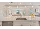 Modern kitchen with a large island with stainless steel sink overlooking living room and fireplace at 5718 Title Row Dr, Bradenton, FL 34210