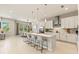 Modern kitchen featuring a large island with seating, stainless steel appliances, and a breakfast nook at 5718 Title Row Dr, Bradenton, FL 34210