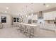 Spacious white kitchen featuring a large island, modern stainless steel appliances, and pendant lighting at 5718 Title Row Dr, Bradenton, FL 34210
