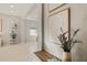 Modern living room showcases a decorative display shelf, artwork, and a glimpse into adjacent living areas at 5718 Title Row Dr, Bradenton, FL 34210